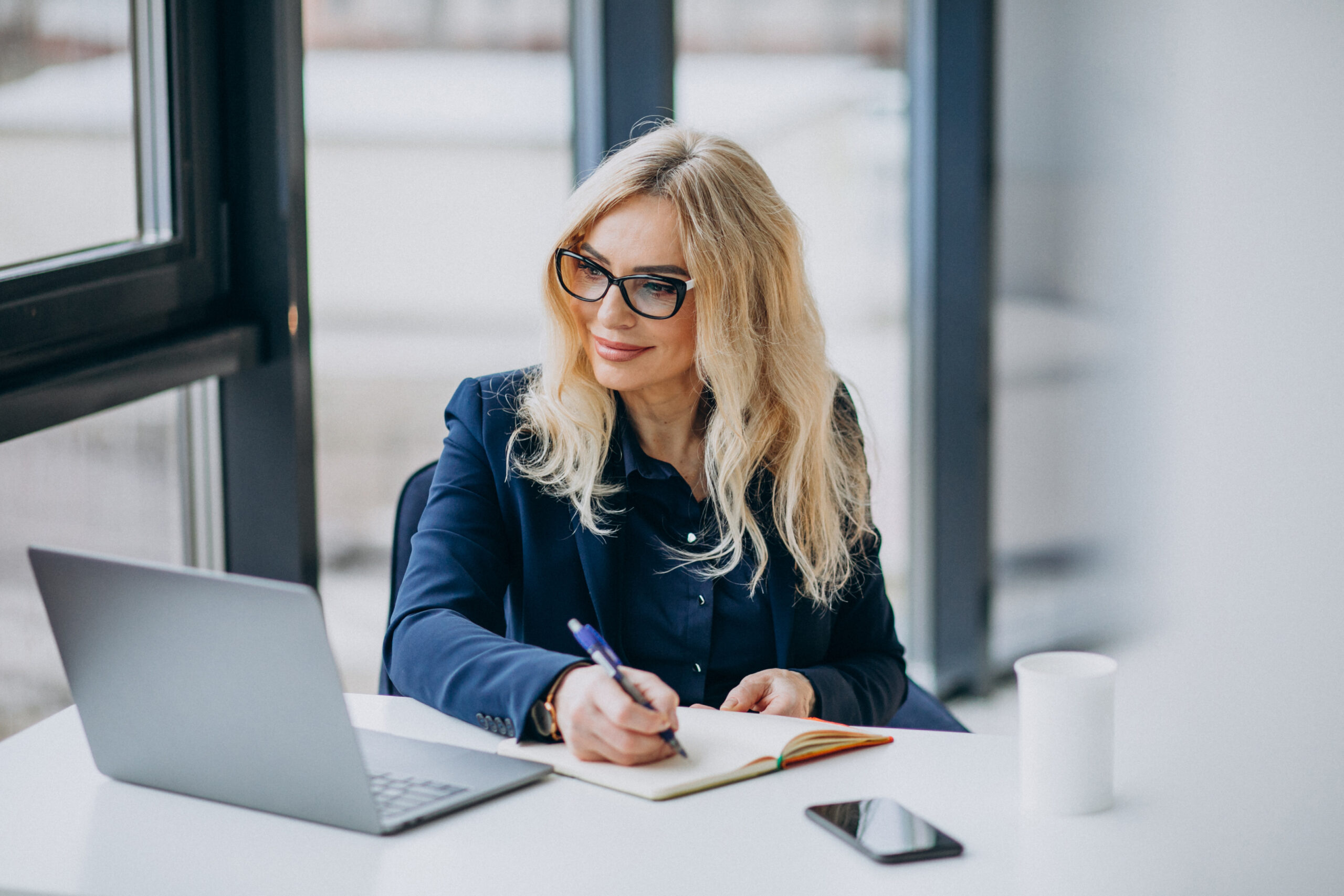 Beautiful middle aged business woman at the office